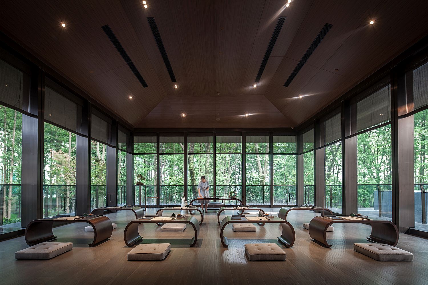 Custom wooden furniture and floor pillows inside the modern Tea House