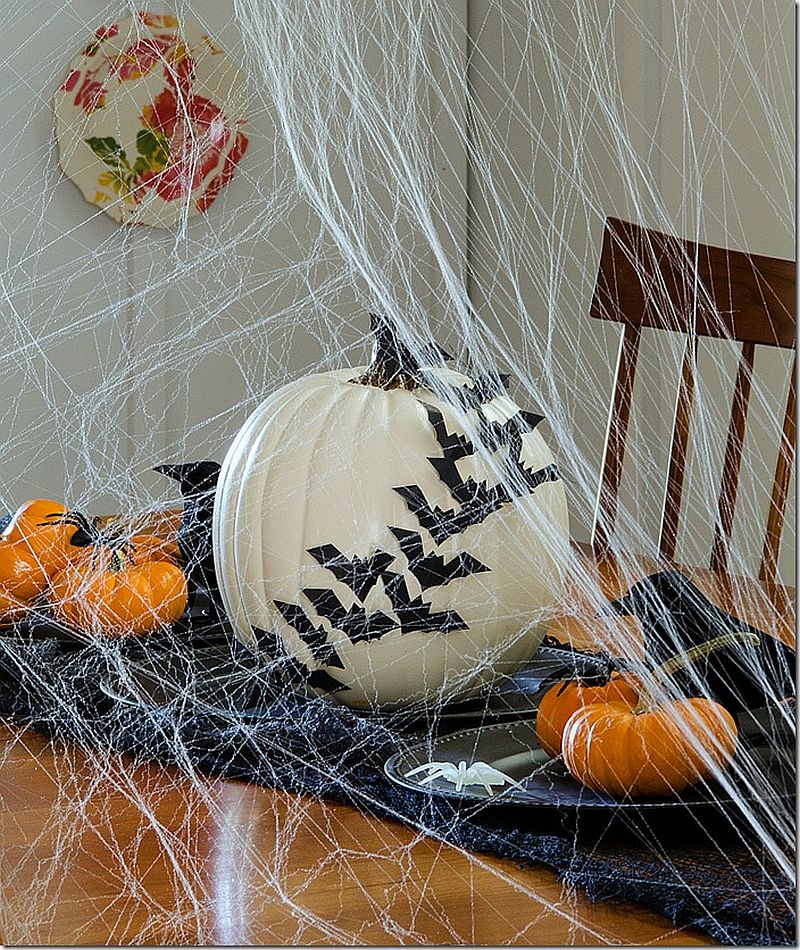 Decorating-with-bats-across-a-white-pumpkin-is-a-great-way-to-create-a-chic-Halloween-table