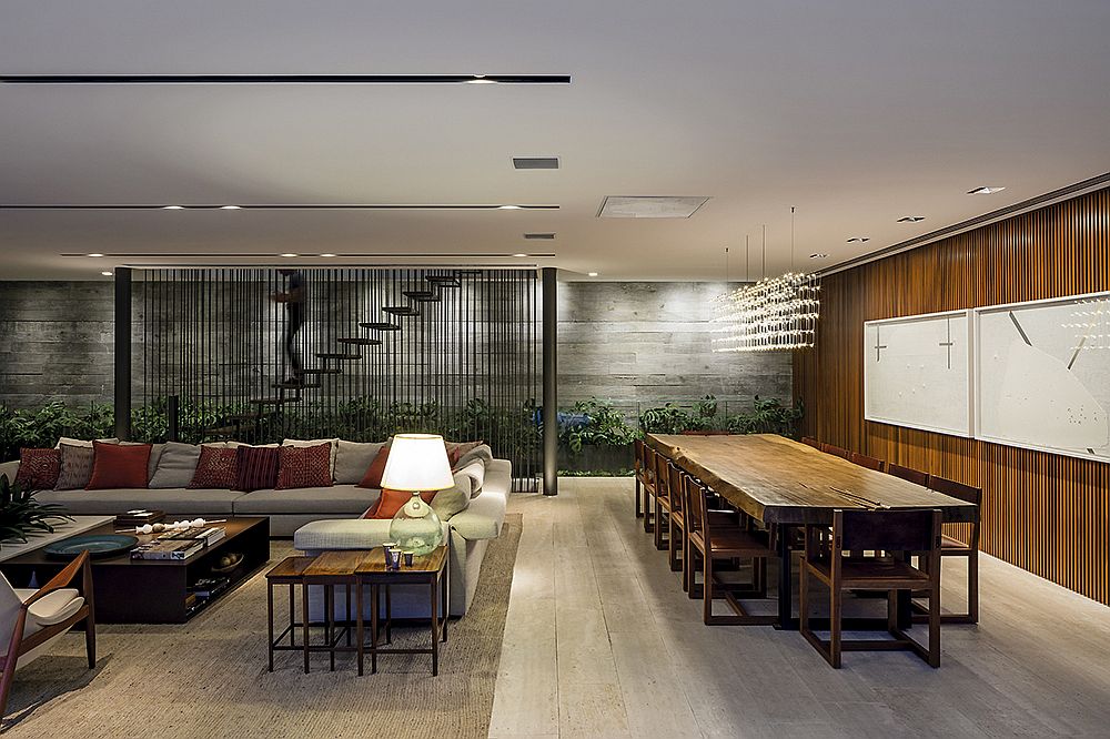 Fabulous chandelier hanging above the dining table with natural wood edge