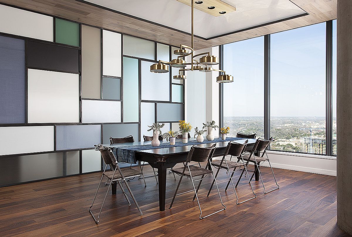 Multi-tasking dining room with a dining table and chandelier that transform into pool table lighting and pool table