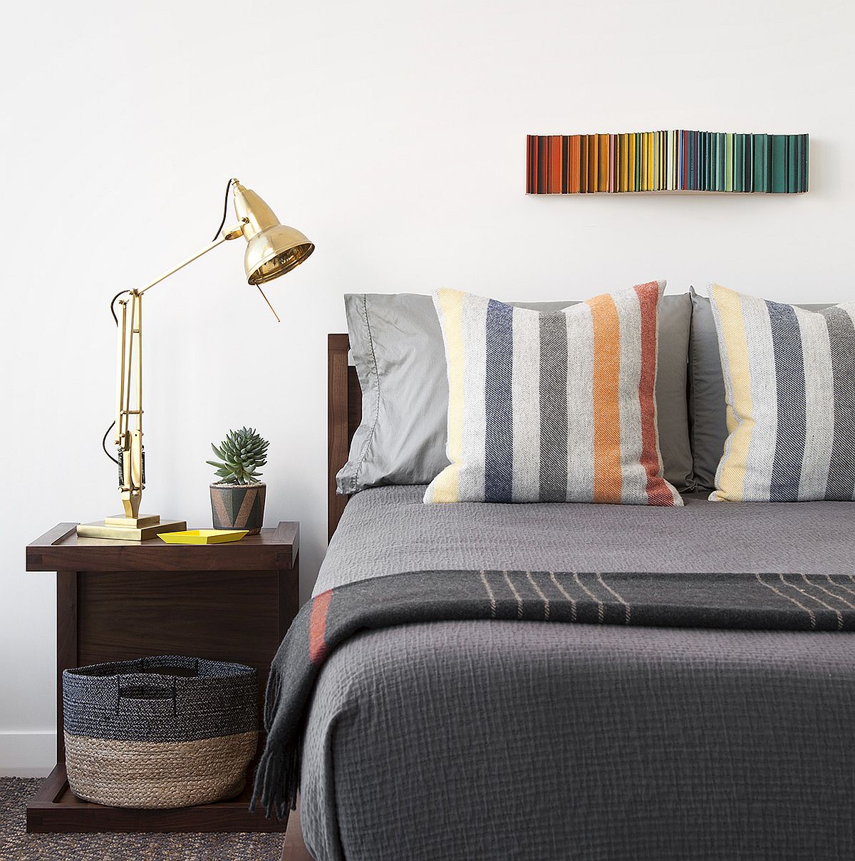 Polished bedroom in white and gray with a cool, space-savvy nightstand