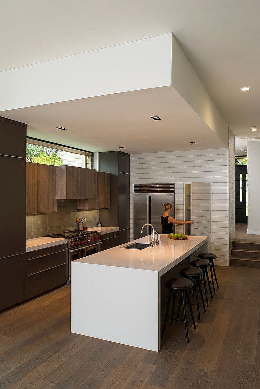 Polished kitchen with pantry and a large central island