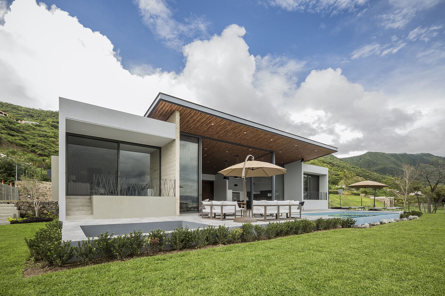 Rear facade of the home with large backyard, pool and Lake Views