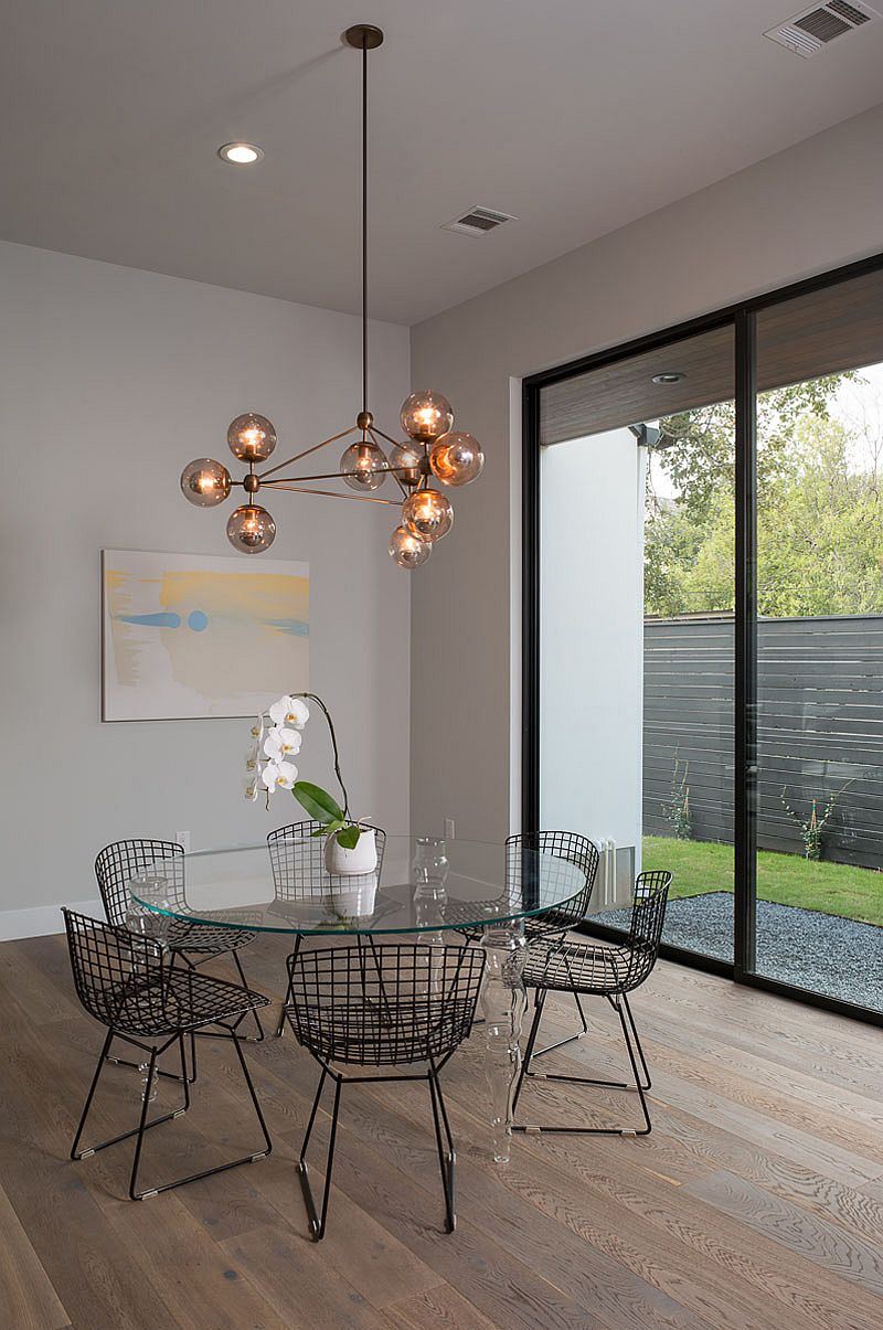 Sparkling chandelier becomes the focal point of the dining area