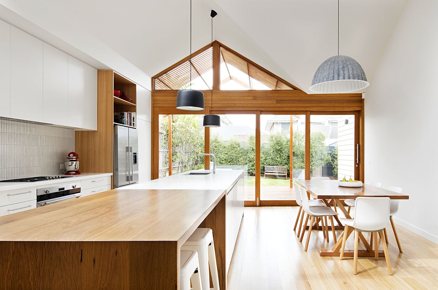 Striking pendants blend into the modern theme of the kitchen