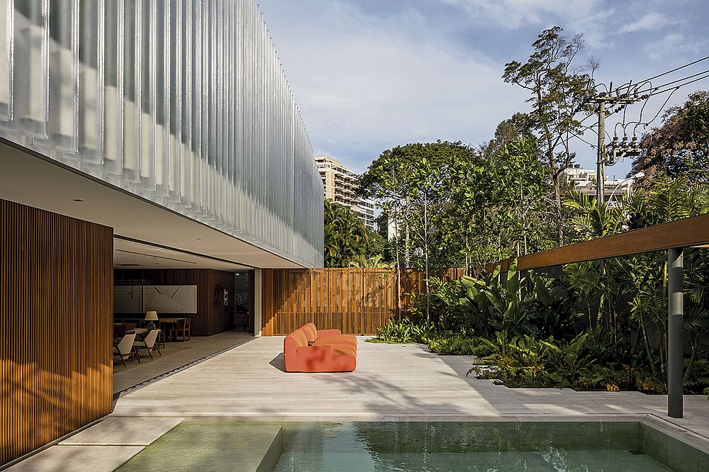 Sweeping deck next to the pool is connected to the interior