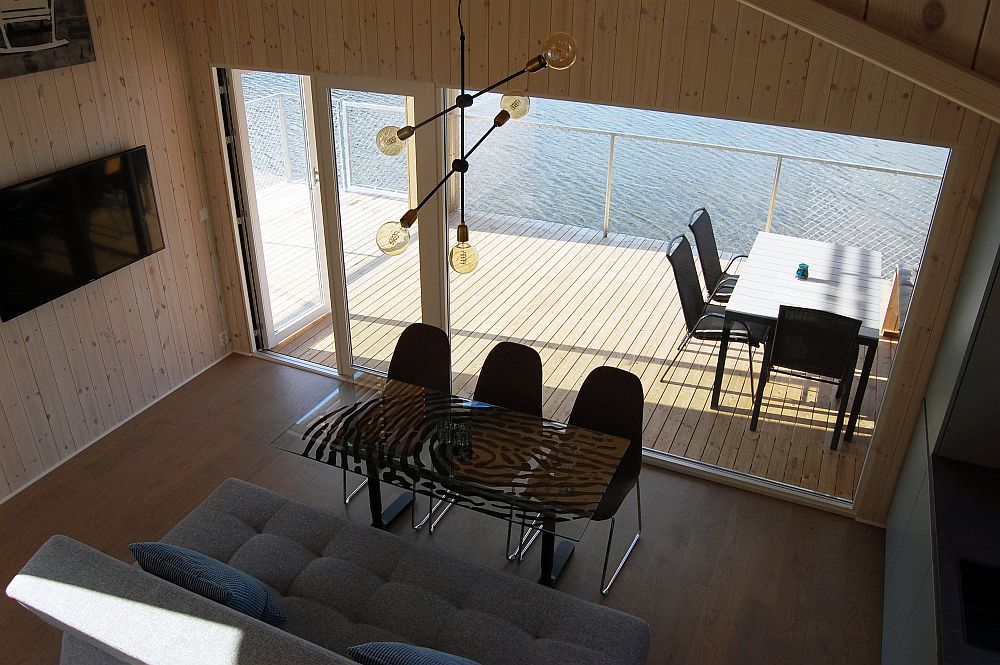 Wooden deck of the cabin seems to float above water