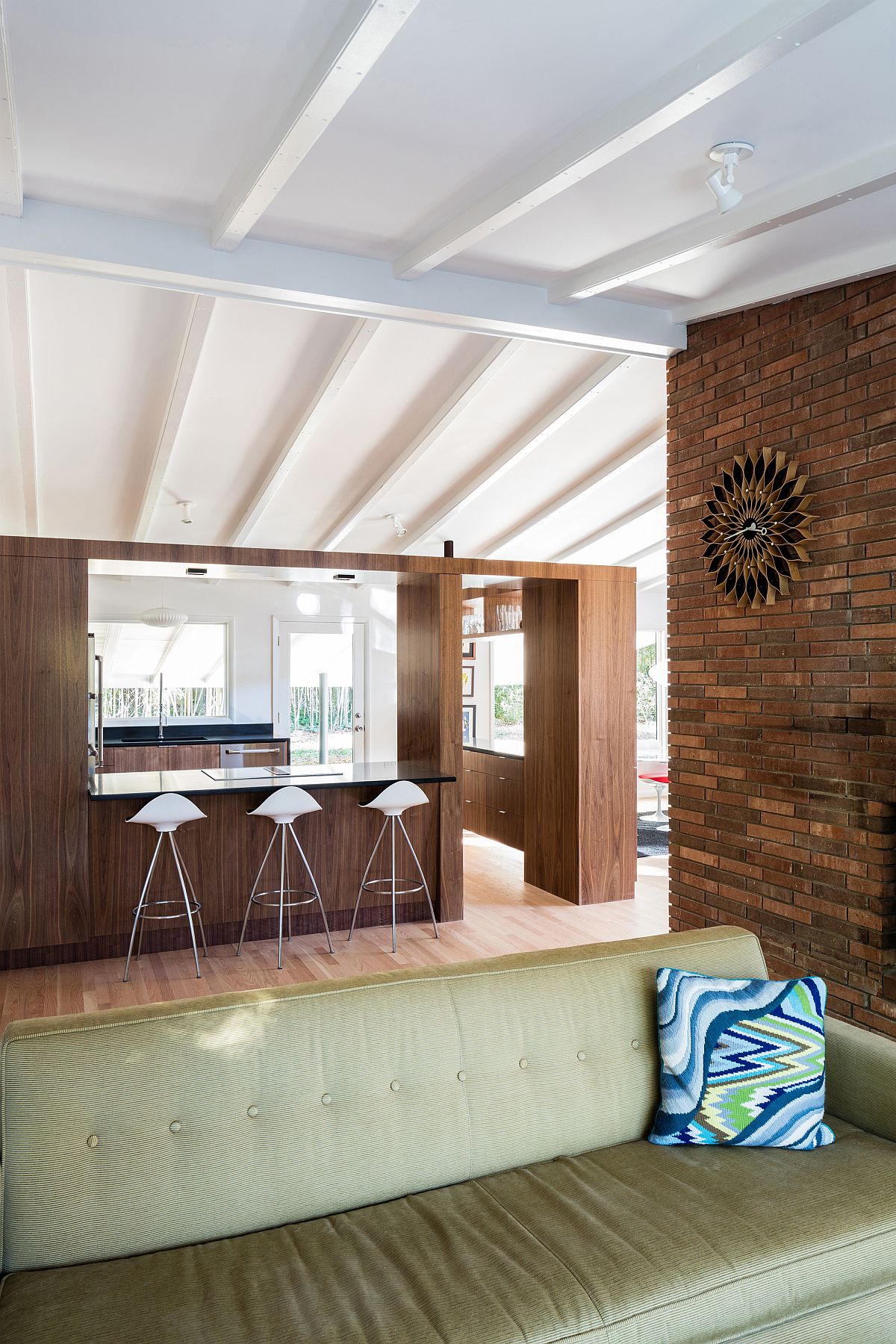 Wooden walls delineate the living area from the kitchen