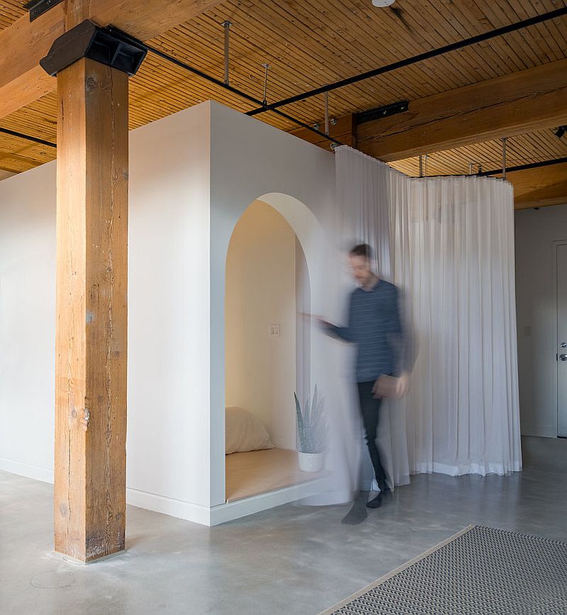 Box-style bedroom with long, white curtains provides space-savvy solution