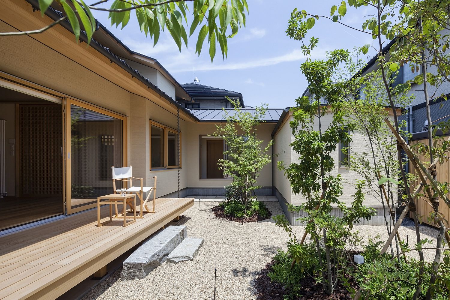 Contemporary courtyard and small wooden deck of the Japanese home