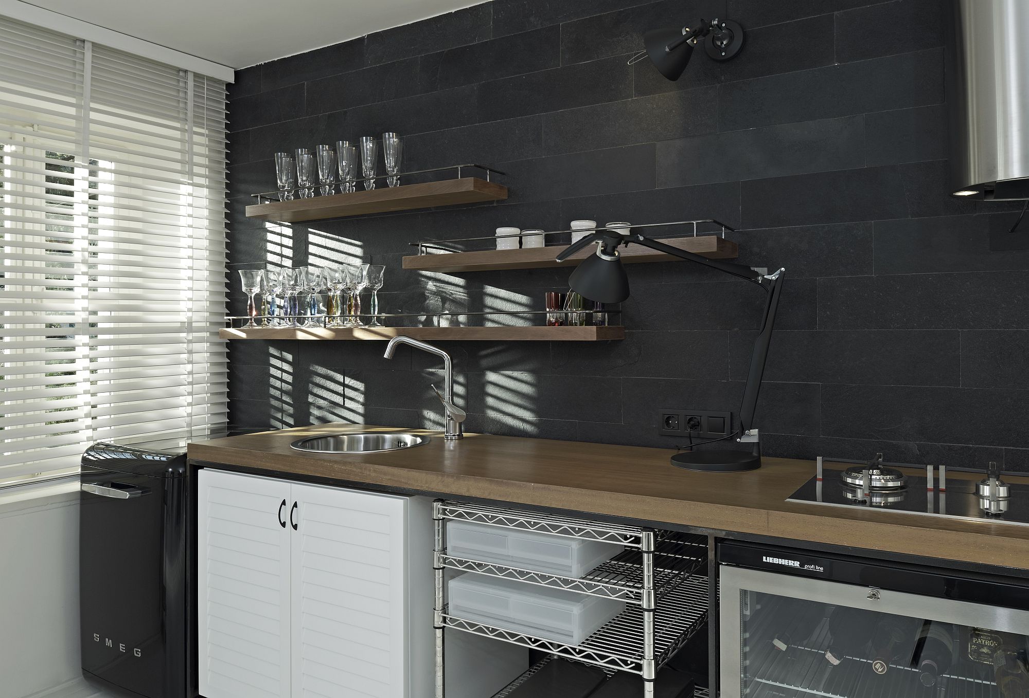 Dark accent wall offers the perfect backdrop for the kitchenette