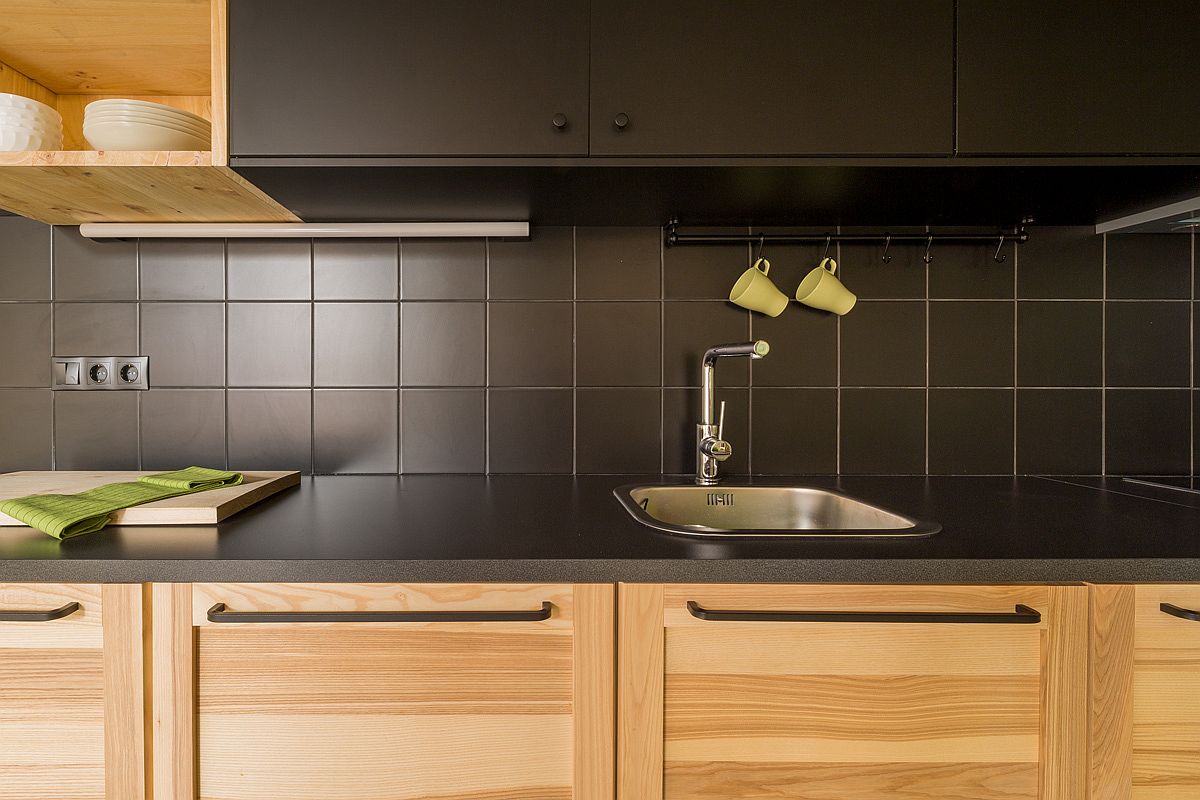 Dark kitchen cabinets and counters coupled with lighter wood tones