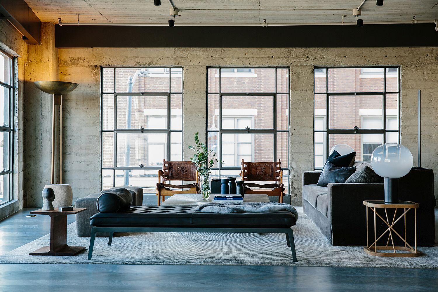 Exposed concrete walls and a polished floor blend in beautifully with the industrial vibe of the home