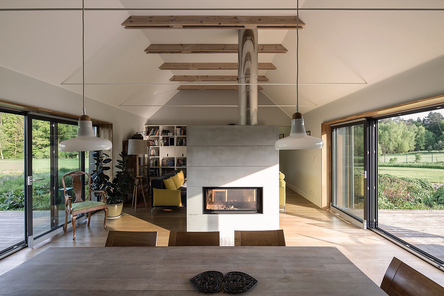 Fireplace delineates the living room from the kitchen and dining