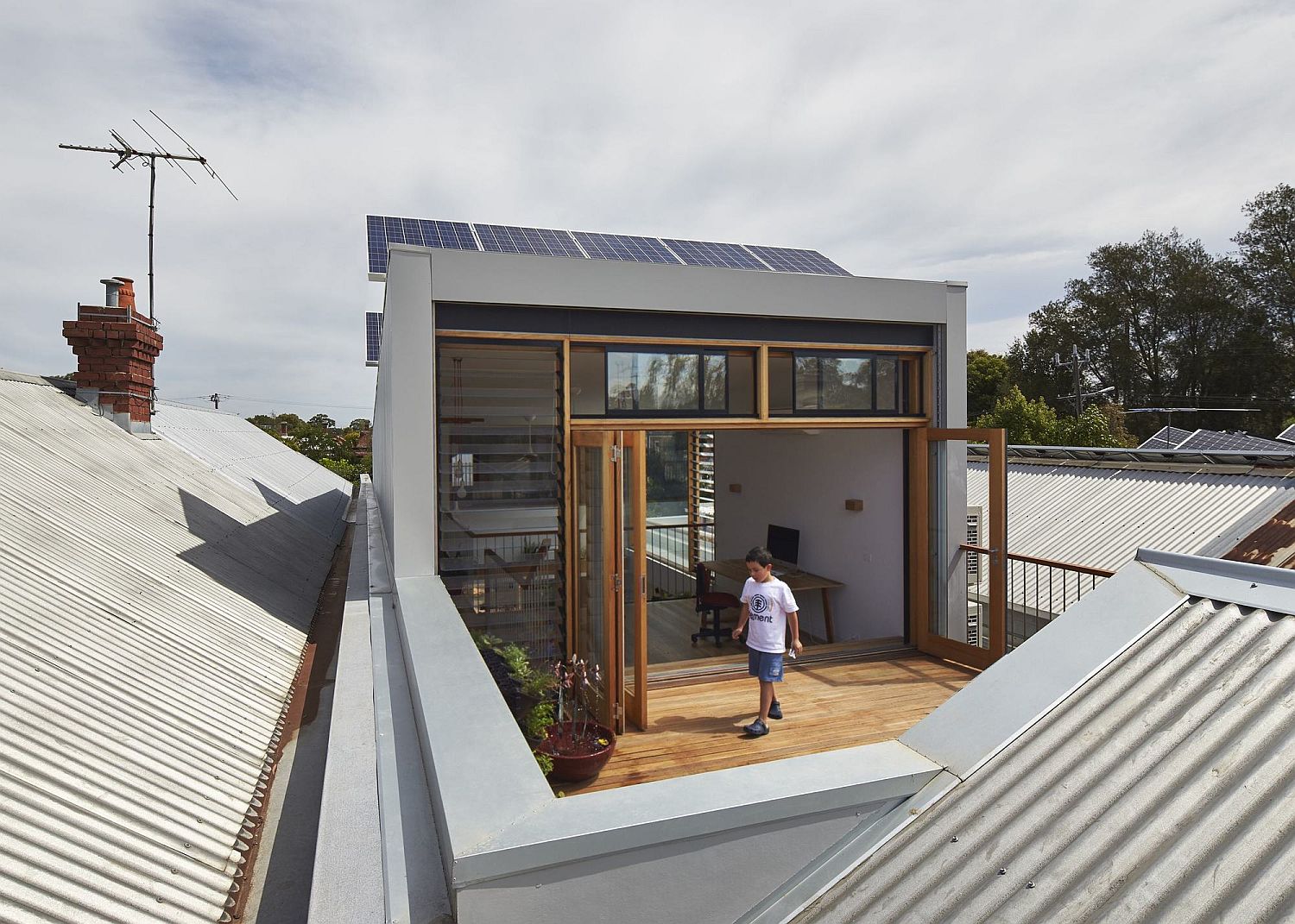 Glass doors and blinds separate the deck from the studio