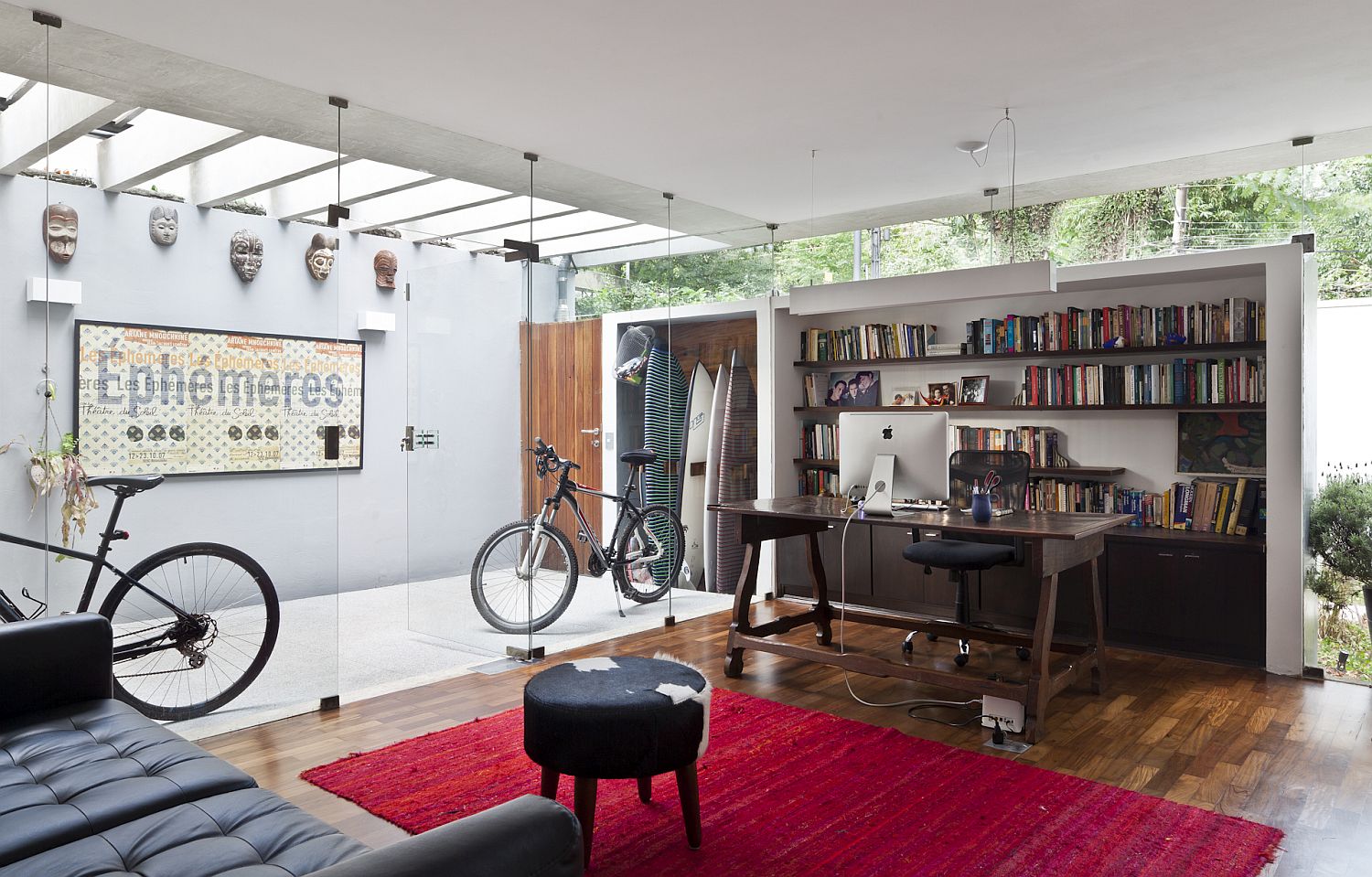 Glass wall separates the mudroom from the home office