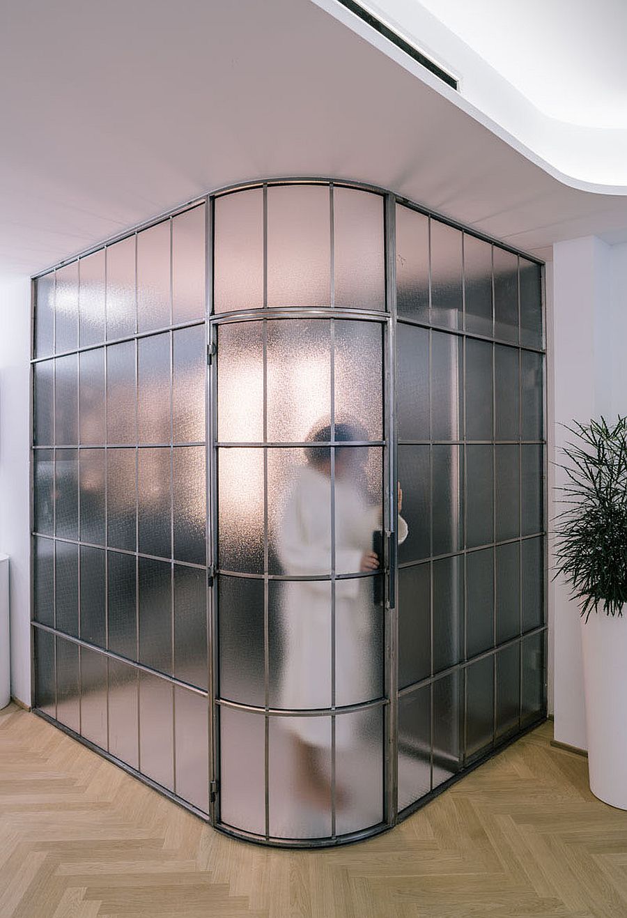 Glass walls and doors create a private and charming bathroom with space-savvy design