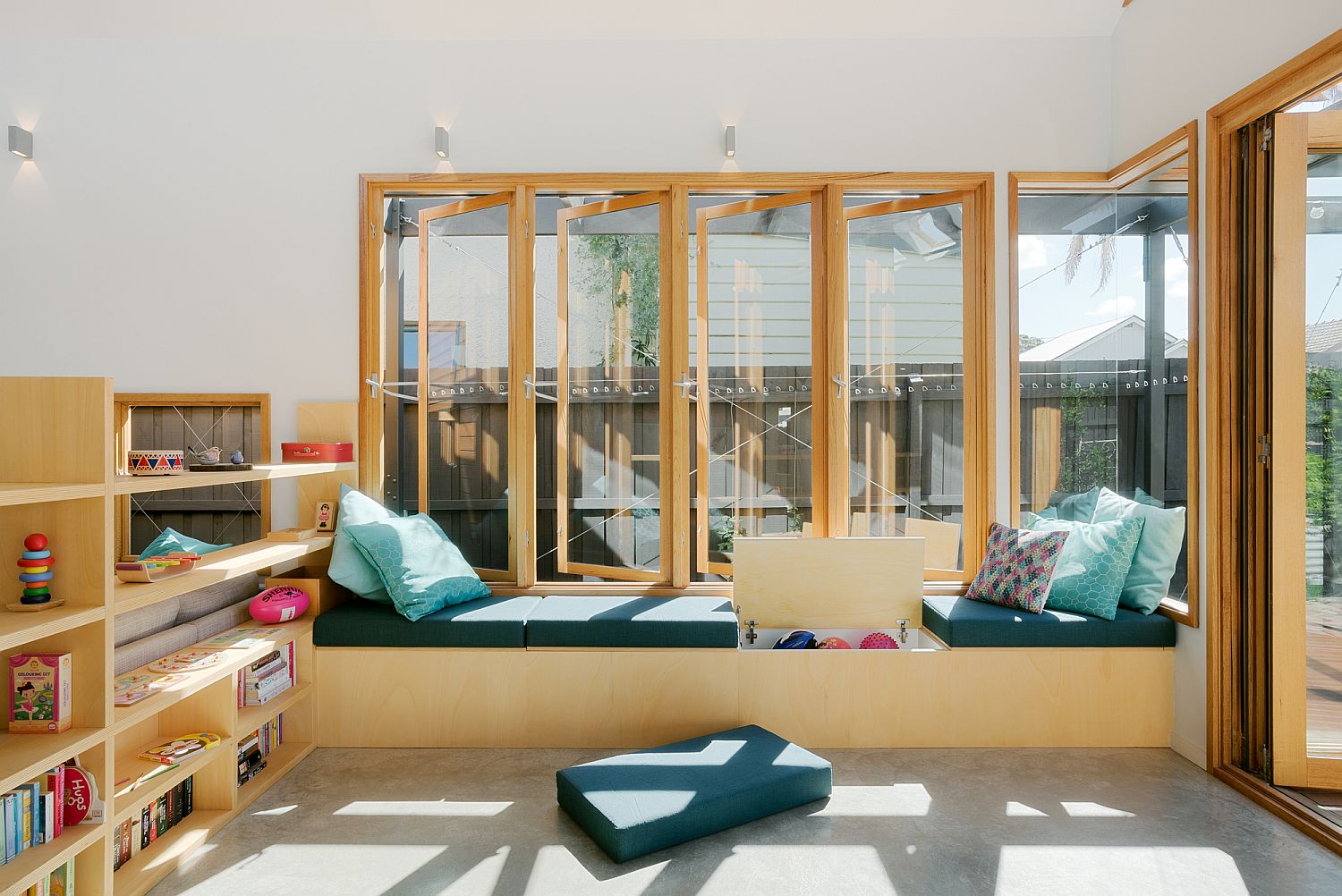 Gorgeous seating next to the window with built-in storage serves in multiple ways