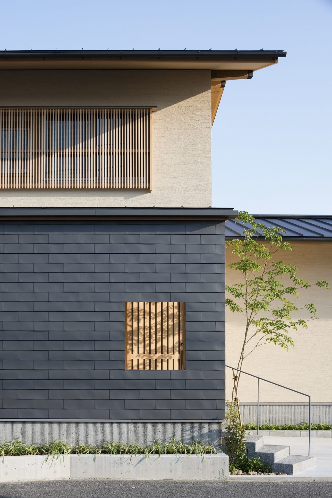Gray exterior of the Japanese home combines modernity with traditional design