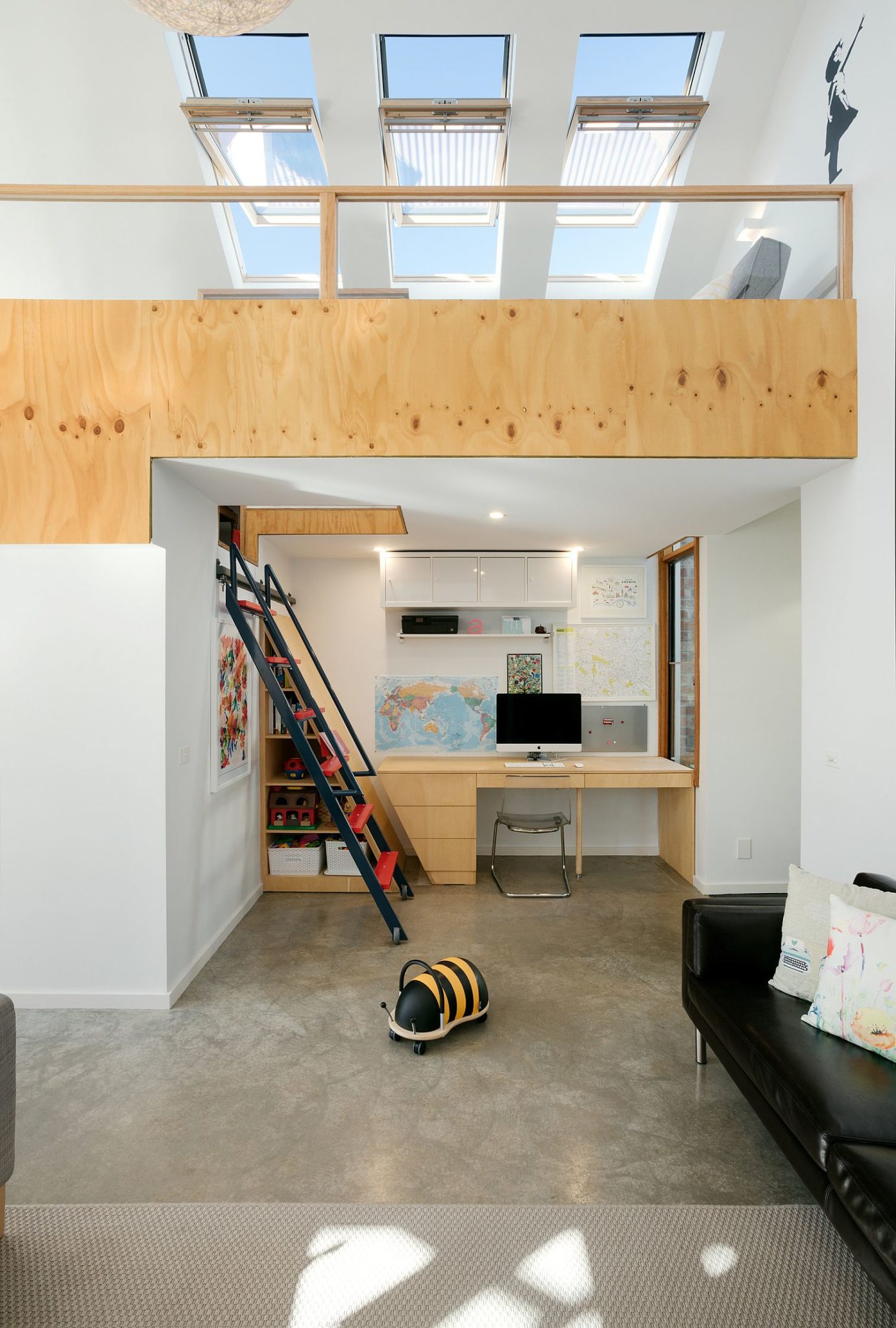 Home work space under the mezzanine level with a simple stairway