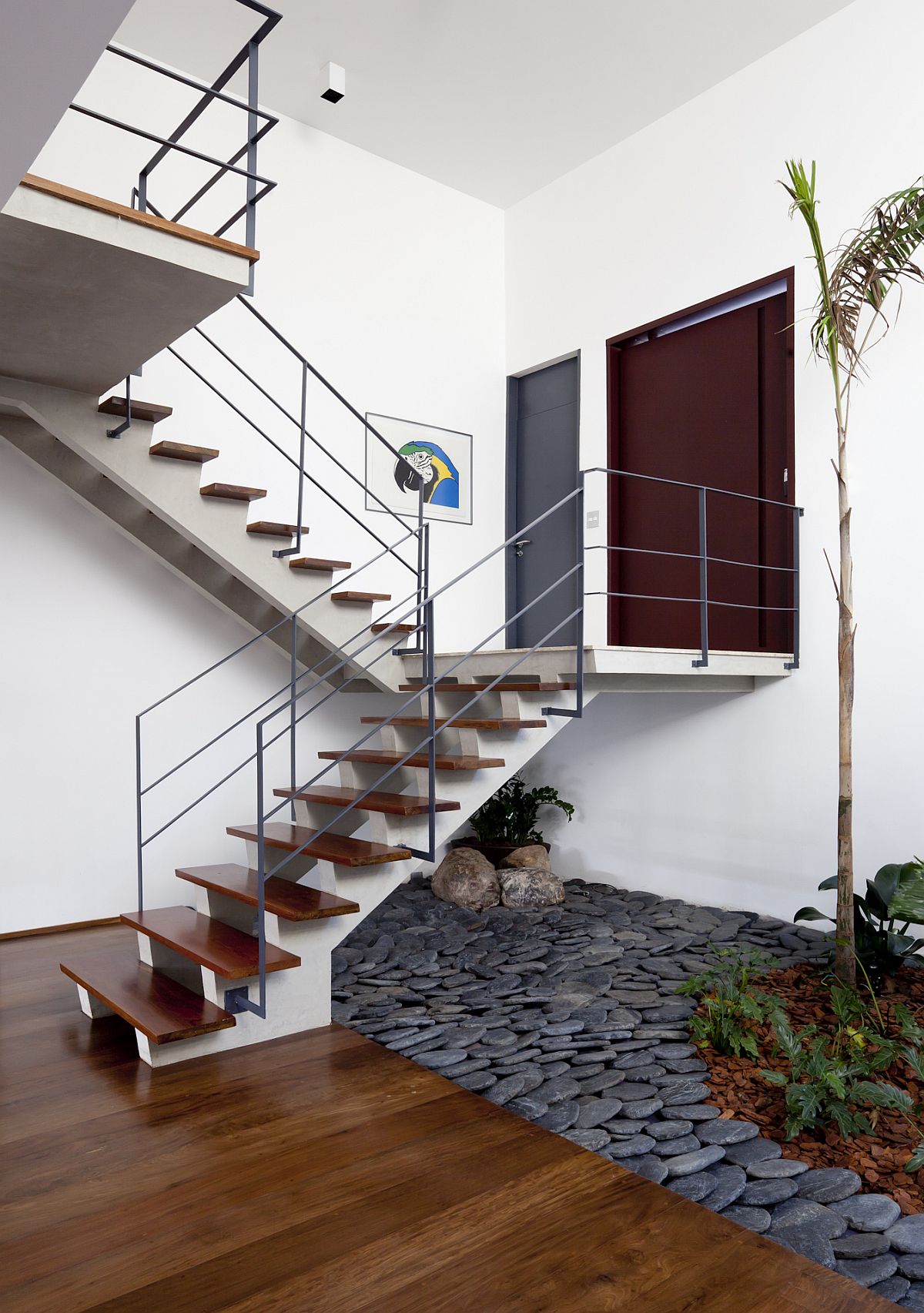 Indoor garden under the stairs with stones all around