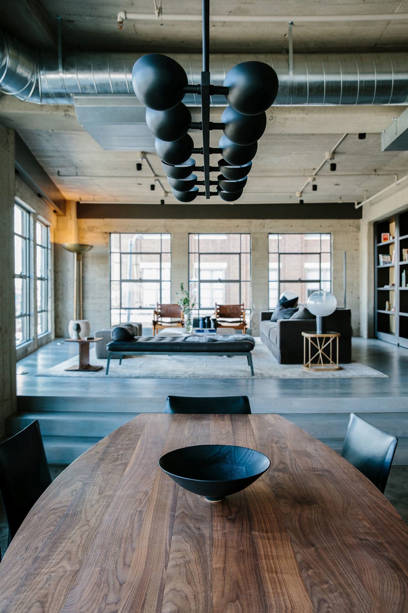 Innovative chandelier lighting in black for modern industrial dining area