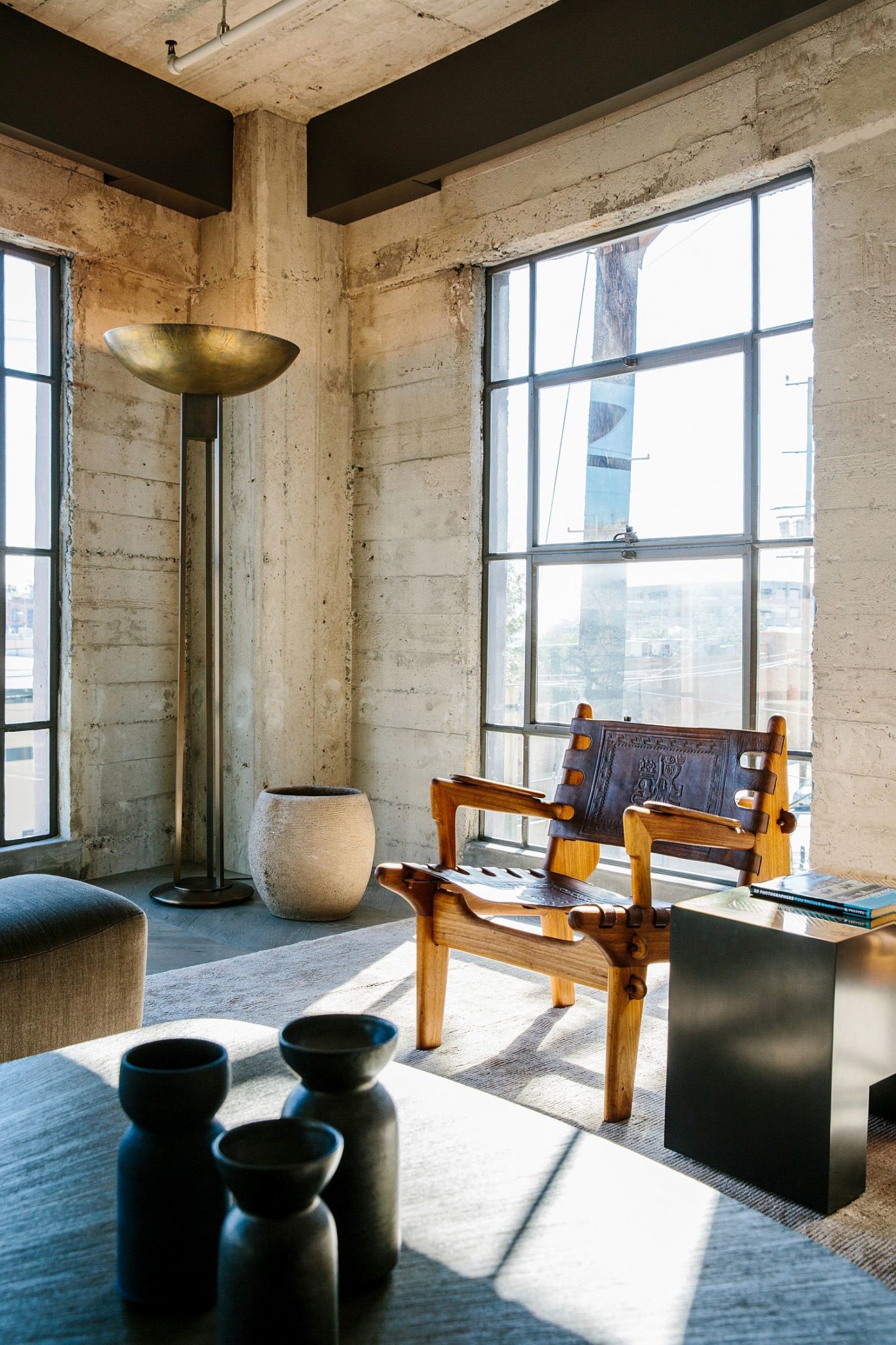 Large windows bring natural light into the modern industrial loft