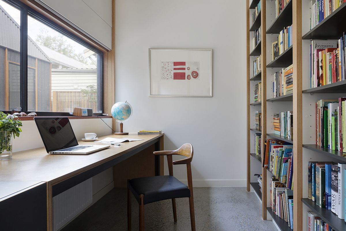 Light-filled home office with large bookshelf