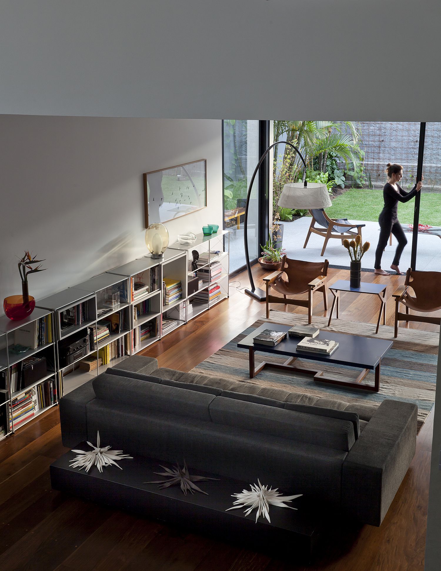 Living room of the Sao Paulo home with modern couch and space-savvy bookshelves