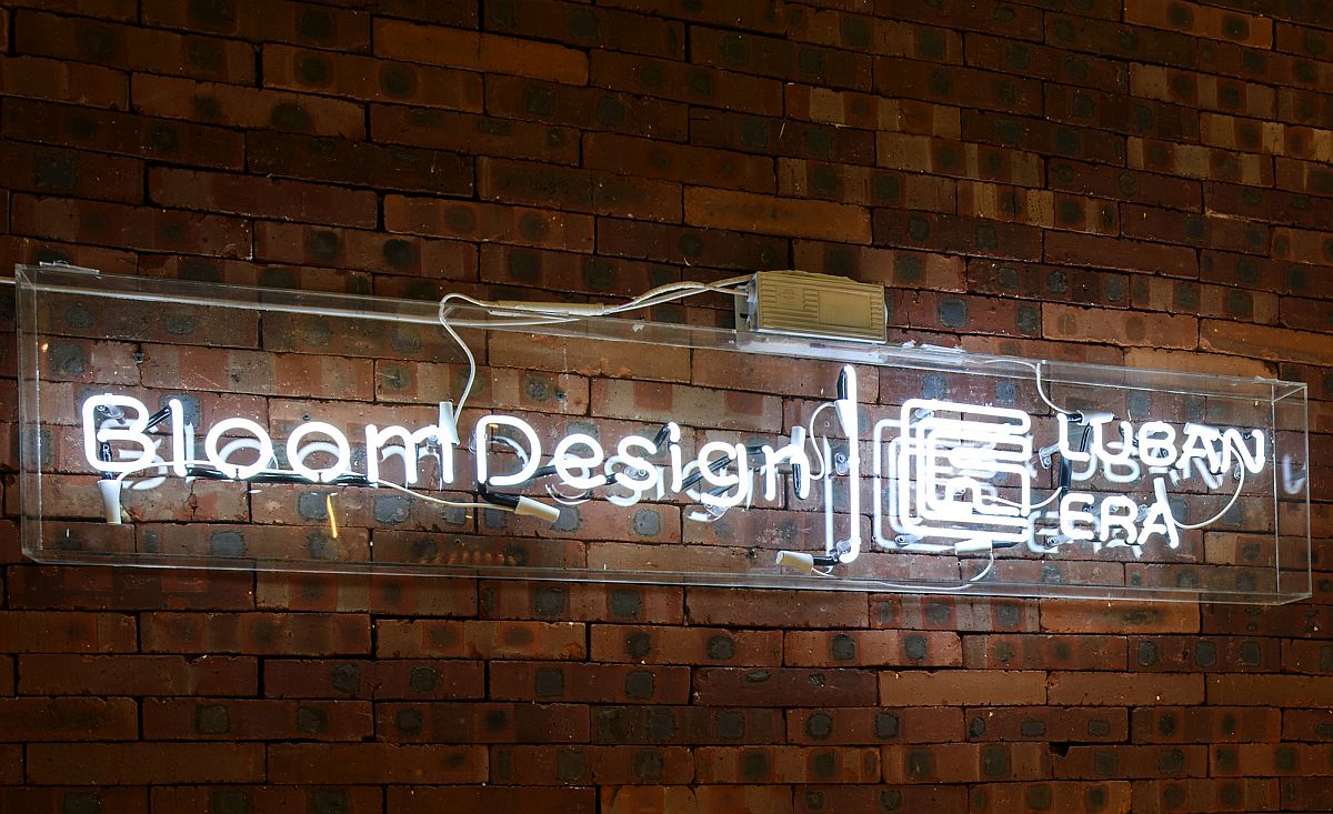 Logo of Bloom Design Studio shines bright against the brick wall backdrop