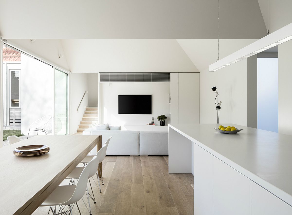 Minimal interior in white with wooden floor and sliding glass doors