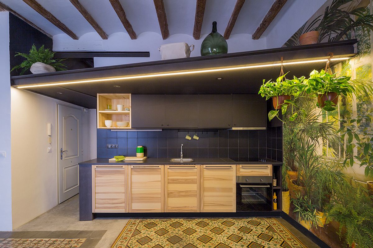 Recamped-dark-kitchen-with-plenty-of-lighting-and-tropical-scenery-next-to-it