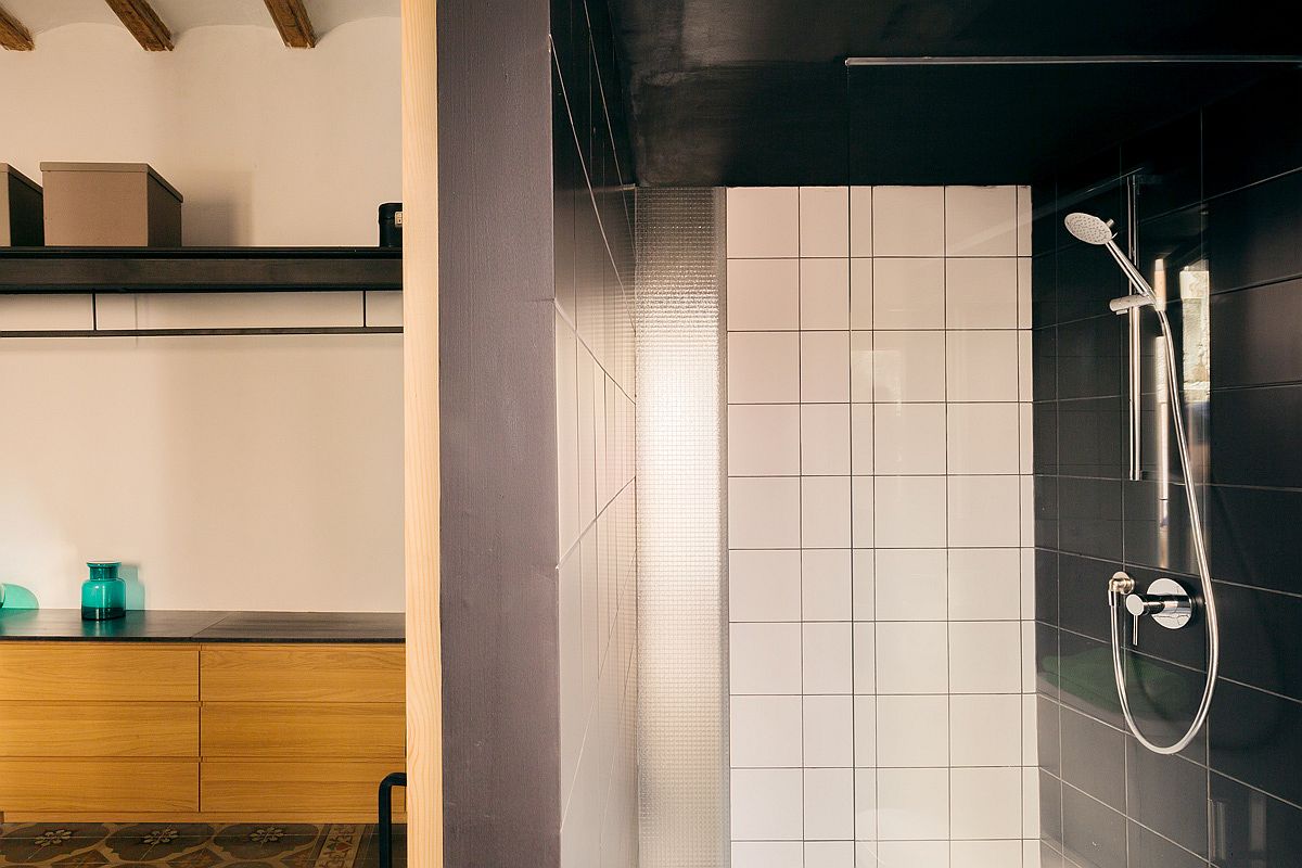 Refined and space-savvy contemporary bathroom in black with natural lighting