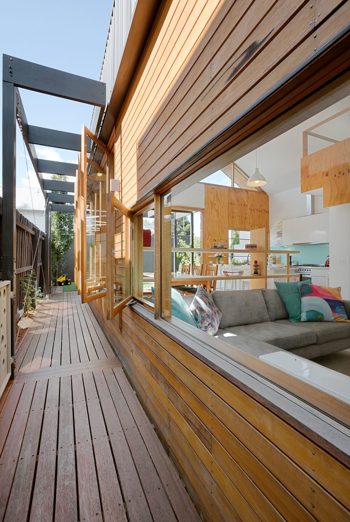 Series of windows and a wooden exterior define the exterior of the Aussie home