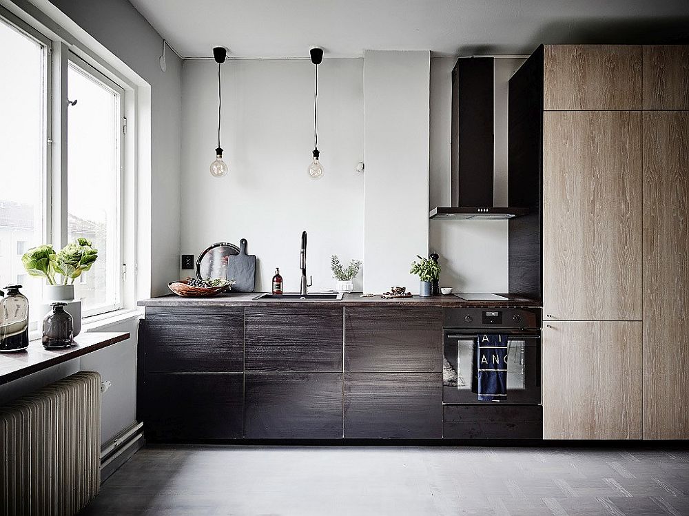 Small kitchen in the corner with different wood finishes