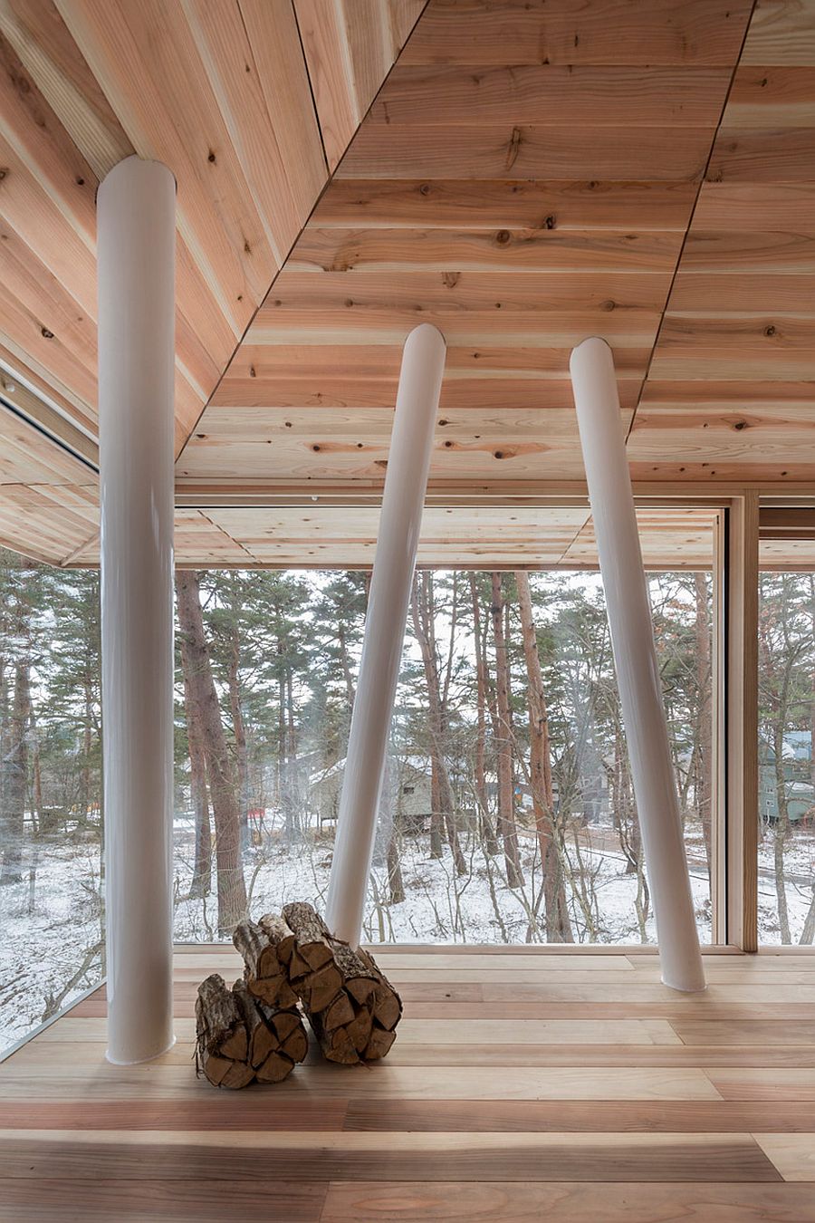 Supporting-beams-inside-the-One-Year-House-draw-inspiration-from-the-trees-outside