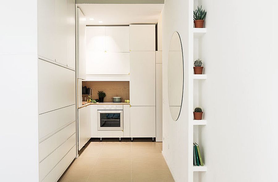 Tiny kitchen in white of micro-apartment in Milan