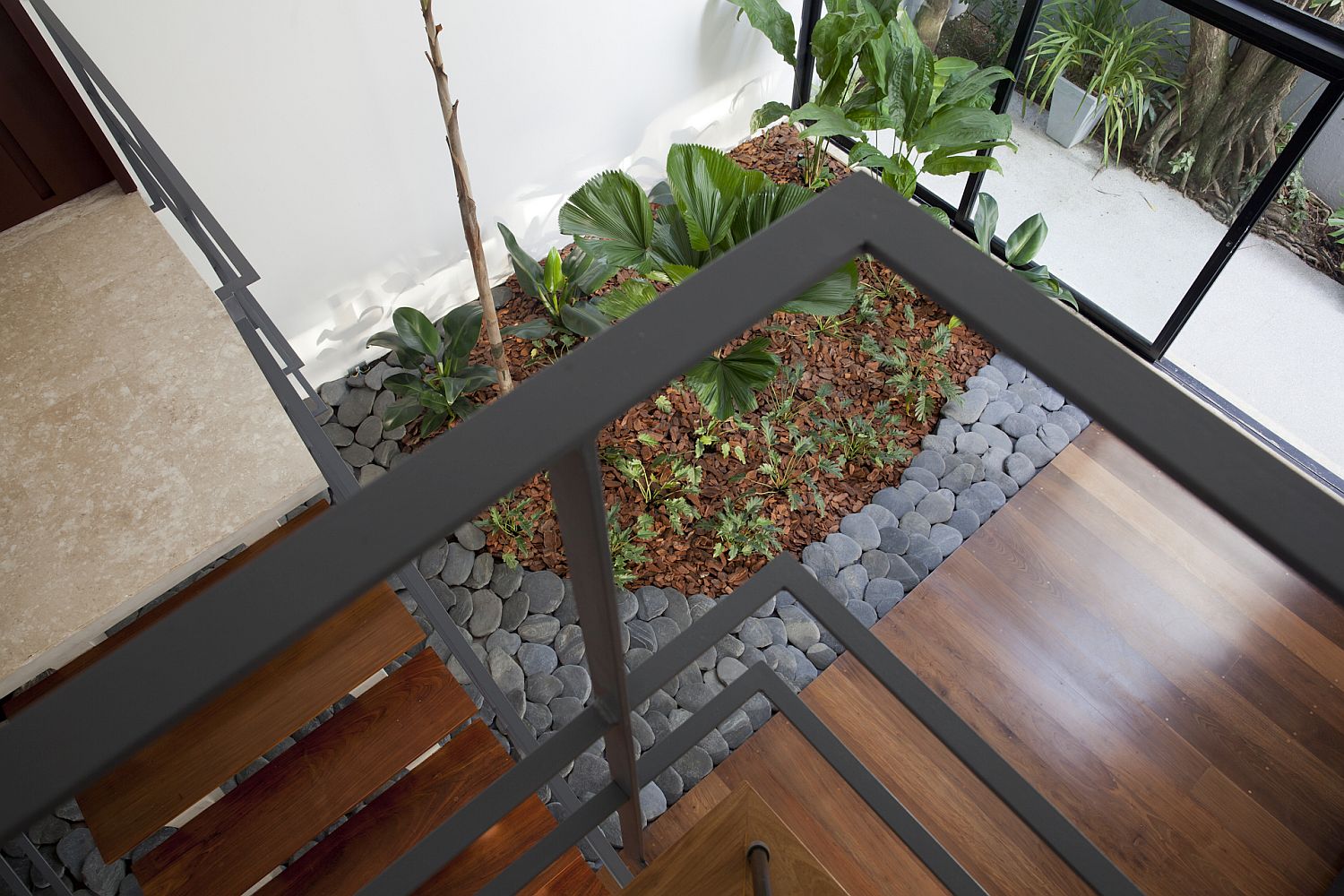 View of the internal garden from the upper level of the contemporary home