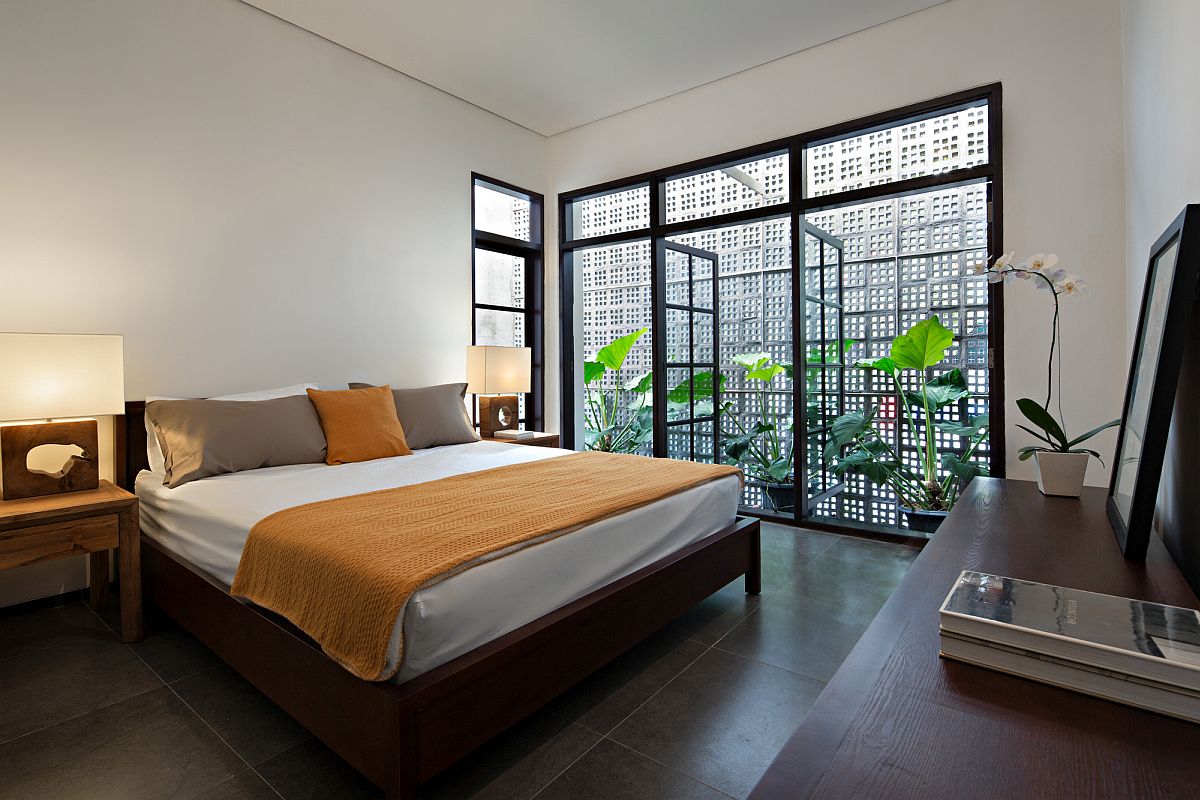 Bedroom with framed glass doors is filled with ample natural light