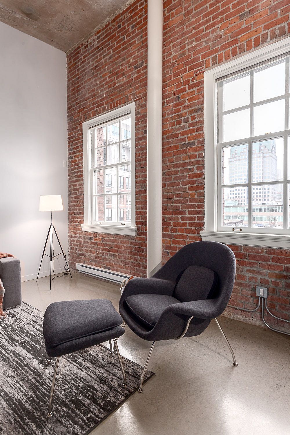 Comfy reading nook with brick wall backdrop and lots of natural light