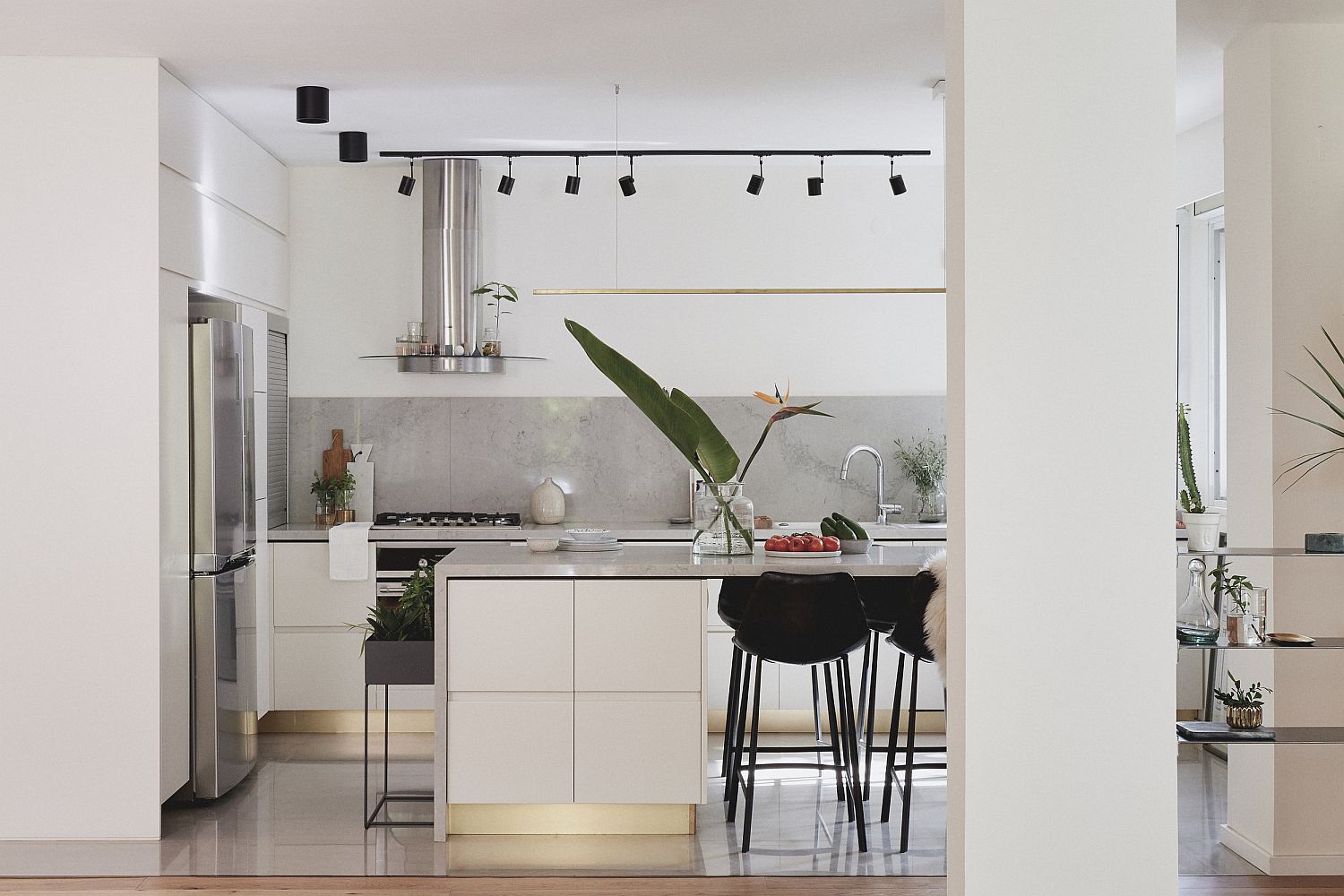 Contemporary kitchen with lovely track lighting and refined, modern design