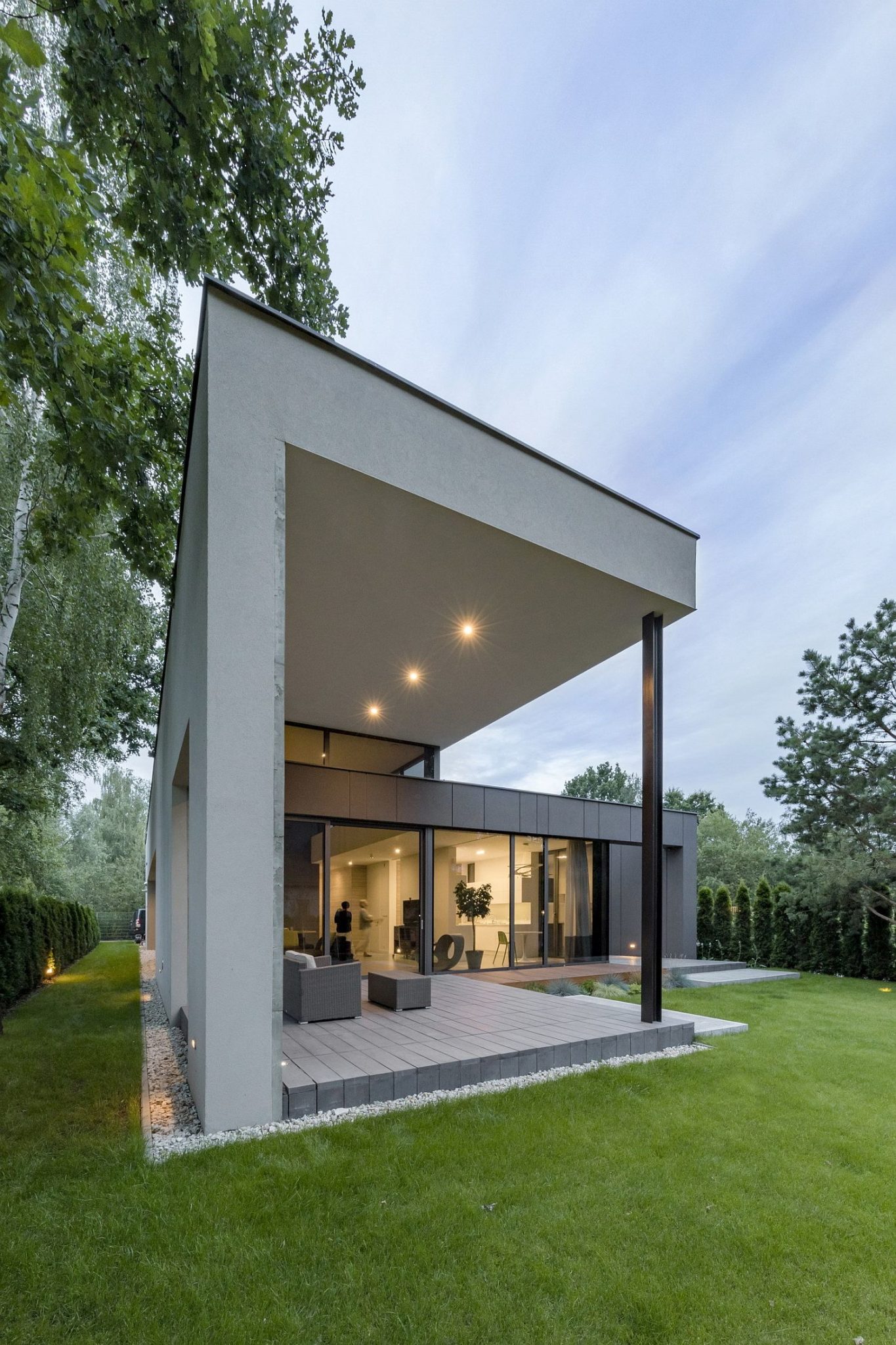 Covered deck with outdoor seating flows into the spacious garden