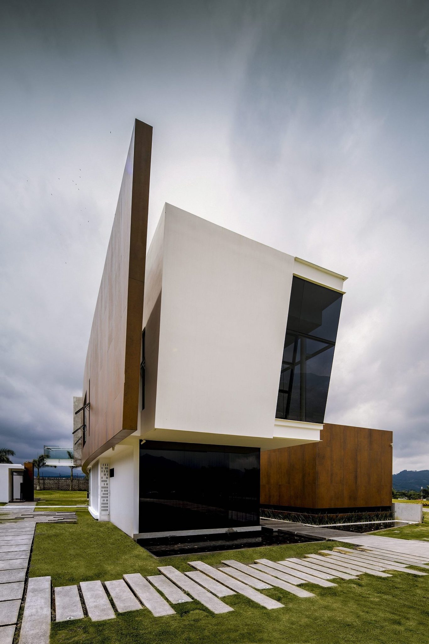 Curved facade of the home along with a wind breaker that also brings privacy