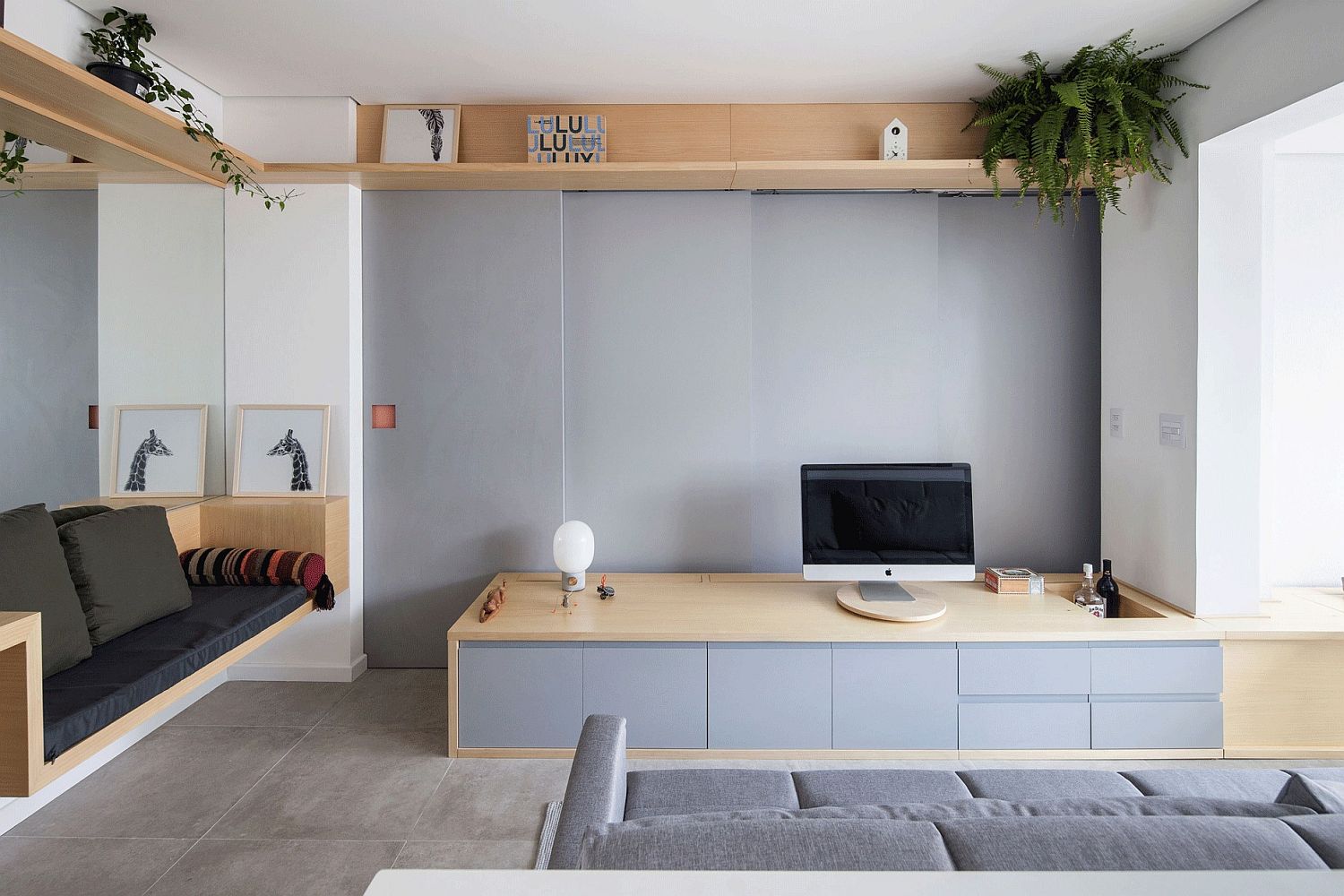 Custom wooden seating and sliding walls for the small living room of Sao Paulo home