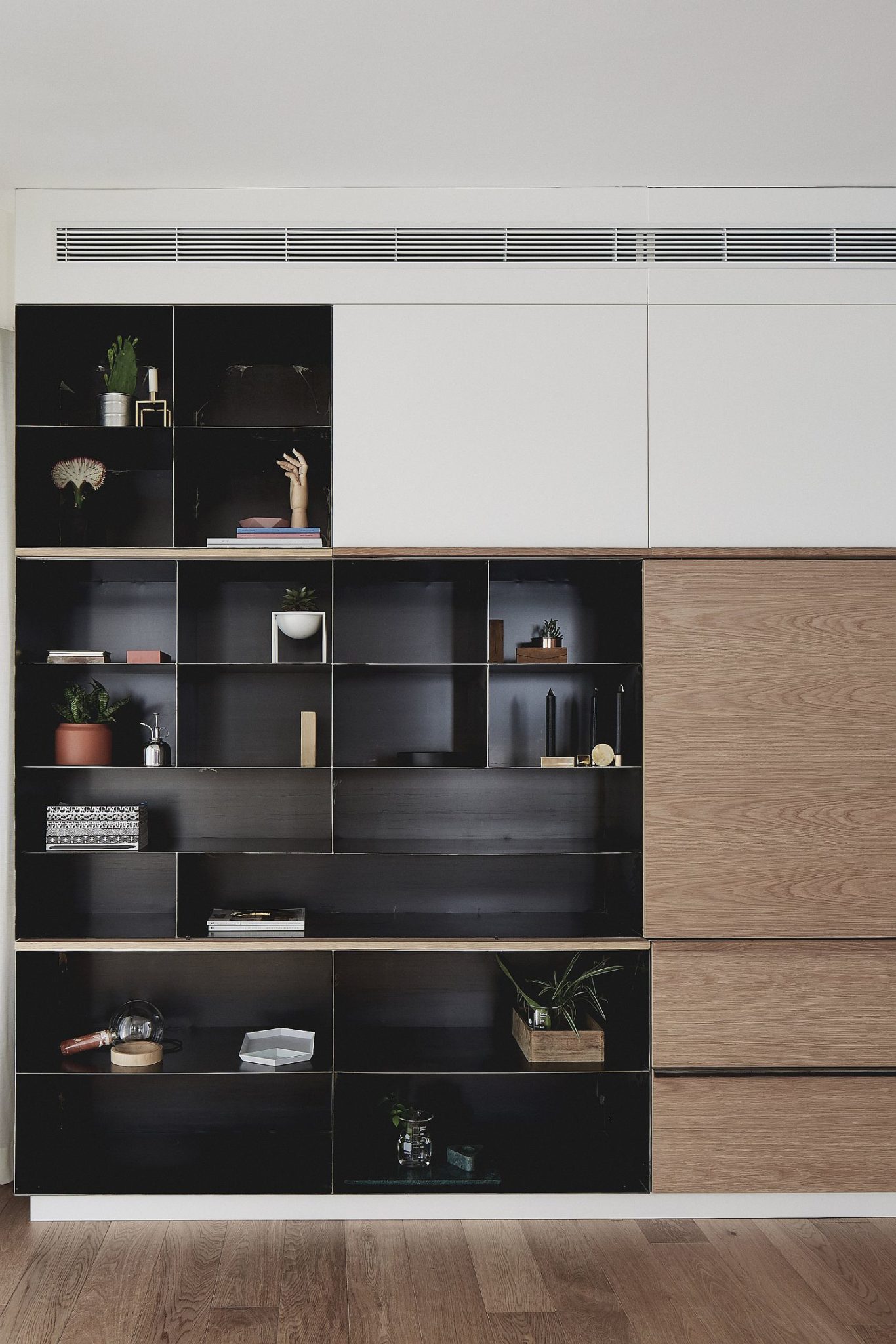 Dark metallic cabinet stands out visually when placed next to the white backdrop