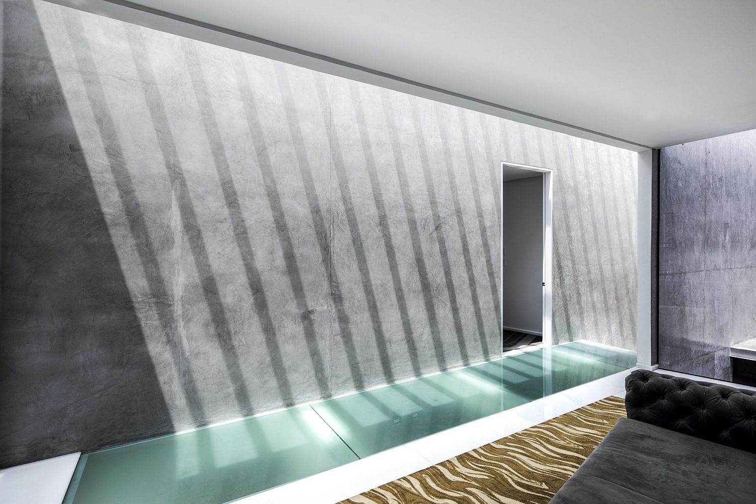 Exposed concrete finishes give the interior a stoic minimal look