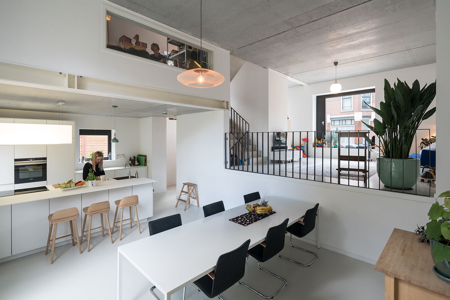 Kitchen and dining area in white on a lower level