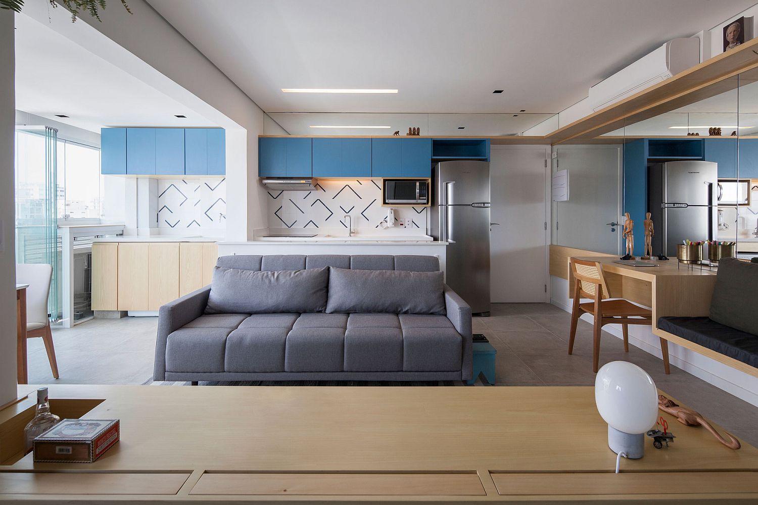 Kitchen-area-of-the-apartment-with-bright-blue-cabinets