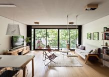 Living-room-with-multiple-seating-options-and-a-view-of-the-canopy-outdoors-217x155