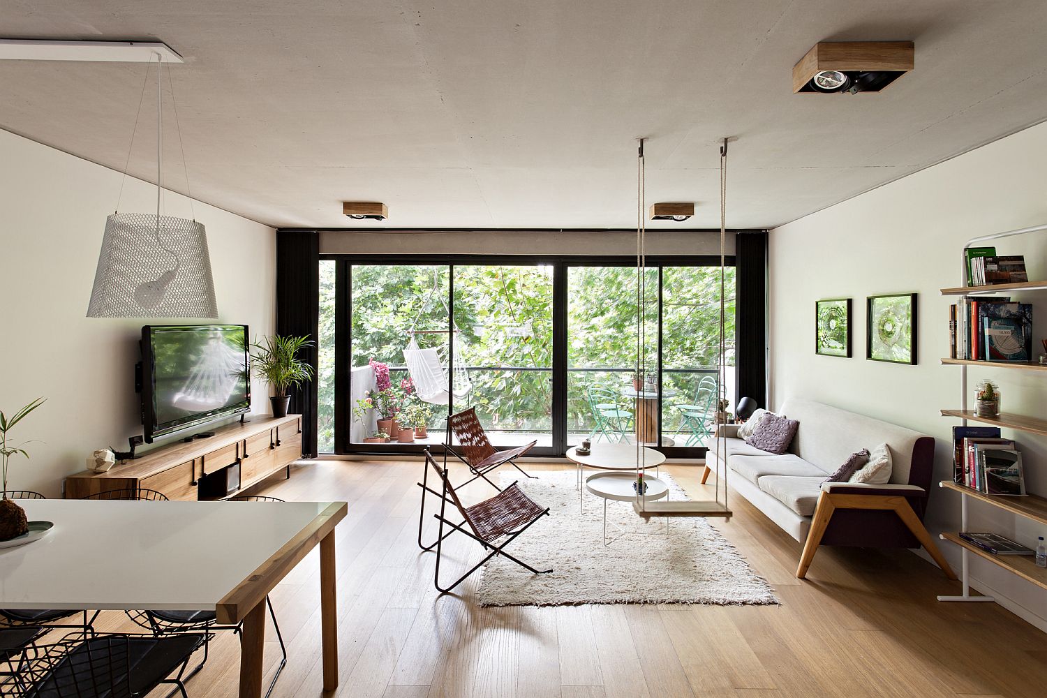 Living room with multiple seating options and a view of the canopy outdoors